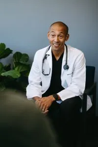 Patient using 24/7 doctor access on smartphone for immediate medical consultation